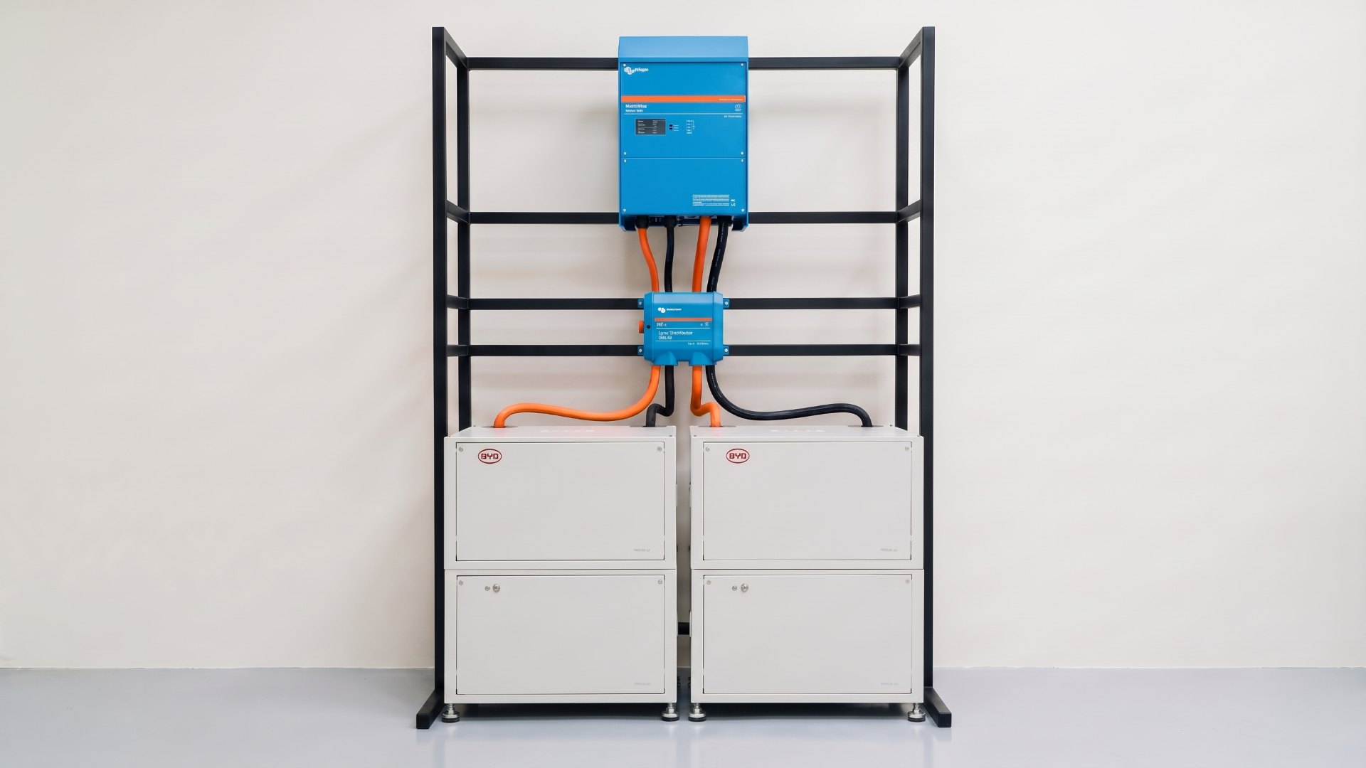 One Always Energy node: a Victron MultiPlus over a Lynx Distributor and two BYD LVL battery towers on a black steel frame