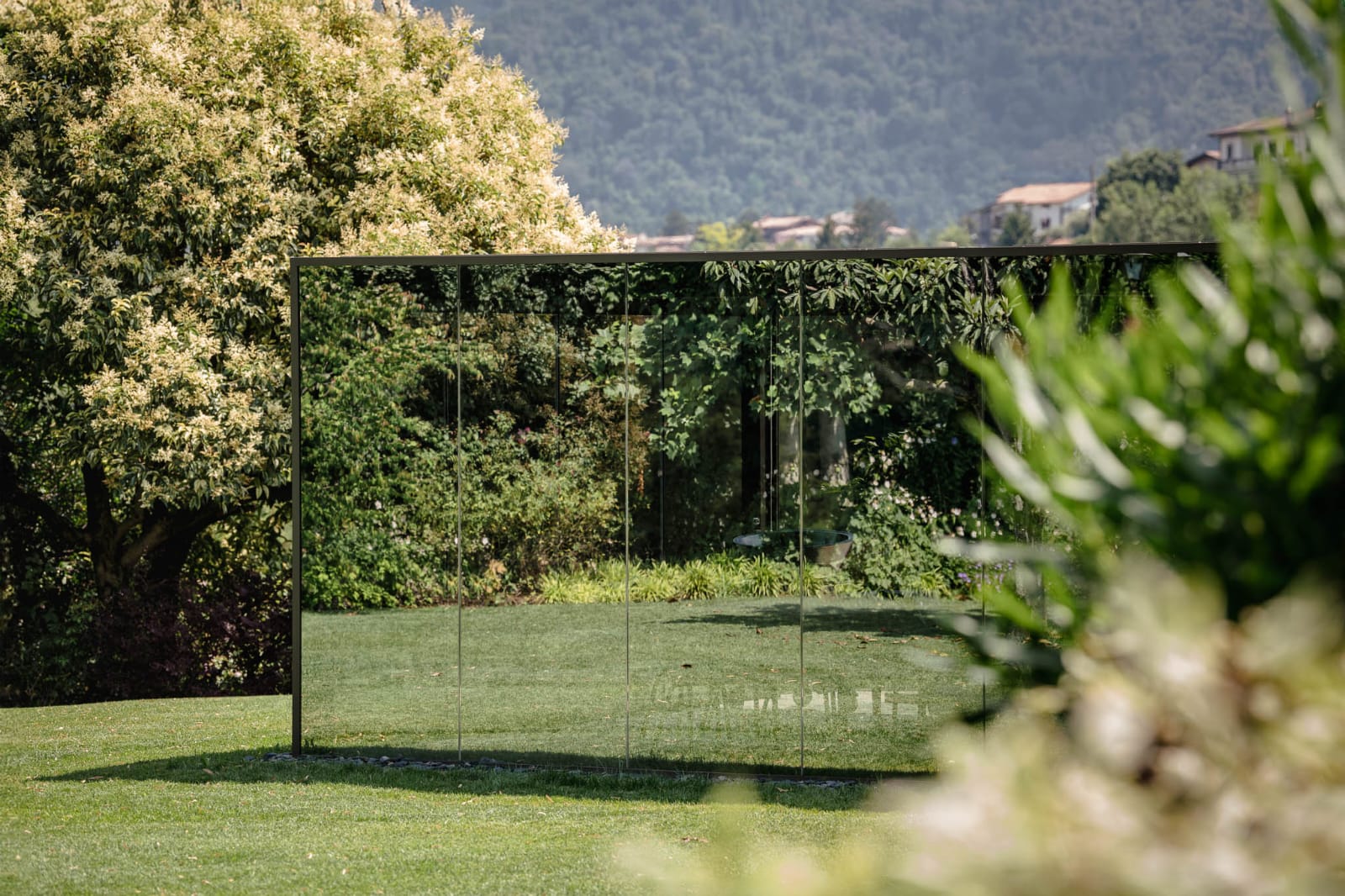 Mirrored pergola beside a lake